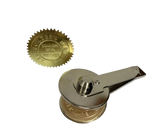 A vintage-style gold seal stamp with a silver metal handle and featuring a gold embossed seal 
